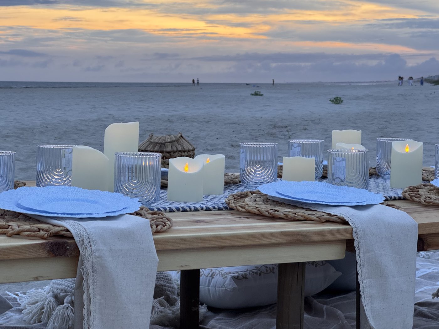 Candlelit dinner table at sunset